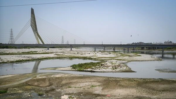 Delhi Water Crisis: Workers creating water channel in Yamuna riverbed