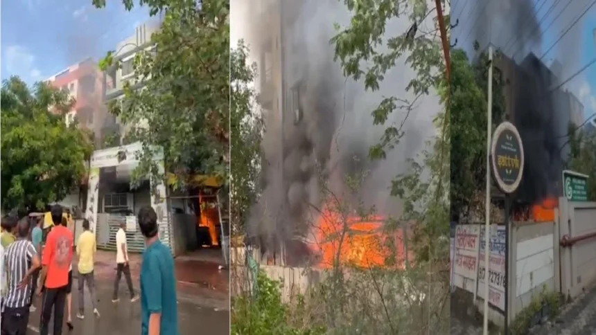 Indore EV Showroom Fire: Firefighters and local residents rescue people trapped above an electric vehicle showroom after a massive fire in Indore.