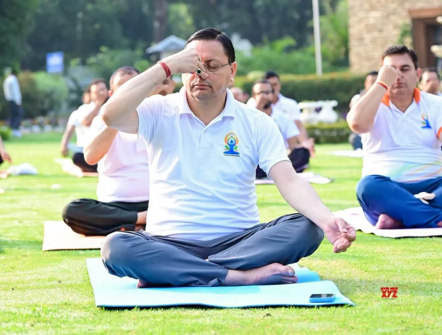 CM Dhami performing yoga with thousands of participants during International Yoga Day 2026 celebrations in Banbasa, Champawat.
