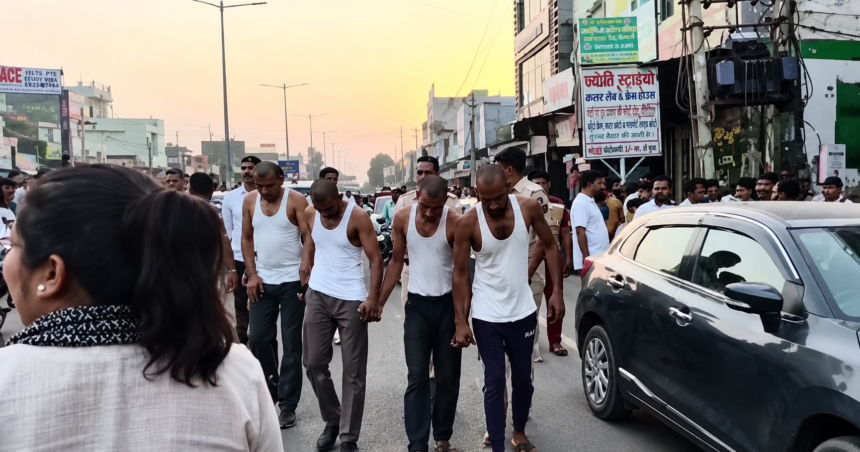Kaithal Police Parade of Criminals – कैथल में पुलिस द्वारा गिरफ्तार आरोपियों को सार्वजनिक रूप से ले जाते हुए, सड़क पर उमड़ी भीड़ और सुरक्षा व्यवस्था का दृश्य।