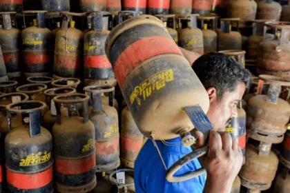 LPG Price Hike 2026: Commercial 19 kg LPG gas cylinders stacked at a distribution center after major hike.