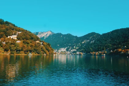 Nainital Monsoon 2026: Naini Lake filled with rainwater during Nainital Monsoon 2026, with mist-covered hills and cloudy weather in Nainital.