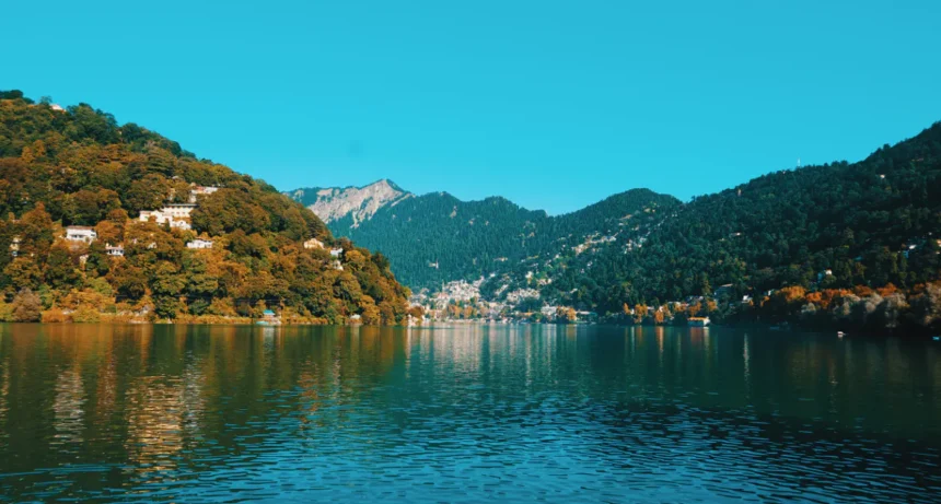 Nainital Monsoon 2026: Naini Lake filled with rainwater during Nainital Monsoon 2026, with mist-covered hills and cloudy weather in Nainital.